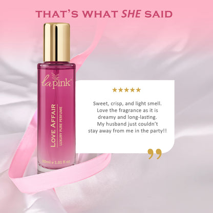 Perfume bottle with pink label on a soft pink background, featuring a customer review.