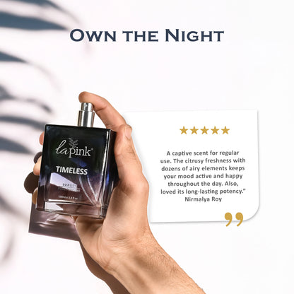 Hand holding a perfume bottle labeled &